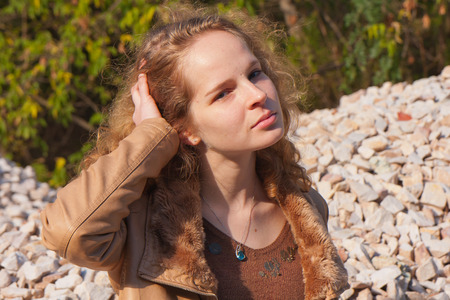 A pretty young woman with blond hair on a walkの写真素材