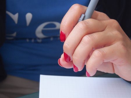 Groomed mighty female hand holding a pen...の写真素材
