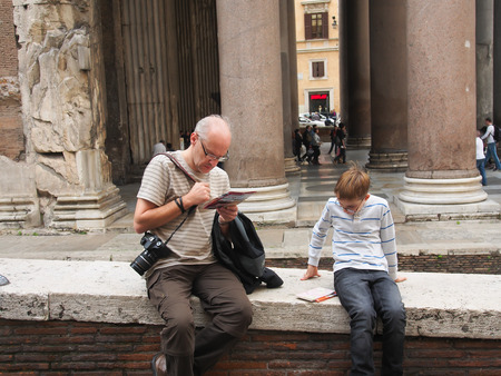 A tourist with a map lost on the streets of Romeの写真素材