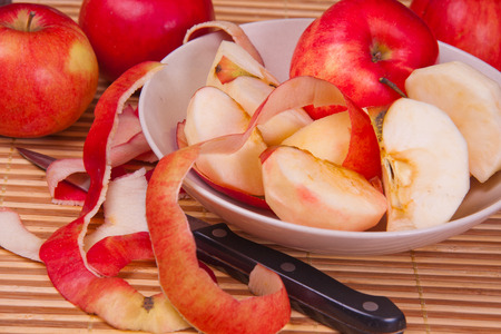Juicy, ripe, peeled, red apples on a table.の写真素材