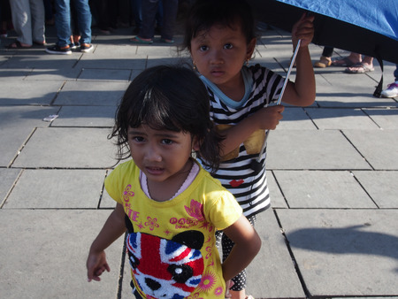 JAKARTA- INDONESIA JANUARY 11, 2015. The joyful and happy local children playing in the colourful crowd of people in the marketplace on a sunny dayのeditorial素材