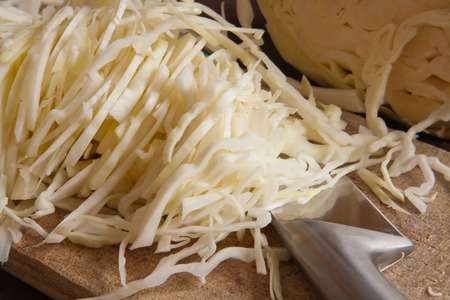 White cabbage cut into fine strips  on a wooden boardの写真素材