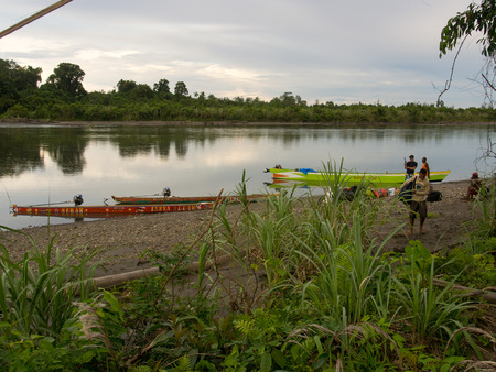 Jungle, Indonesia - January 13, 2015: Colourful boats  on the banks of the riverのeditorial素材