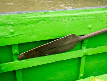 Wooden paddle leaned against  the  side of the boat when sailingの写真素材