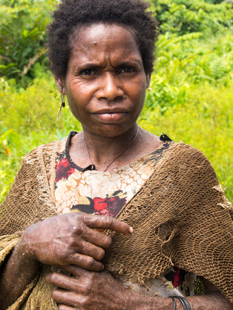 Dekai, Indonesia - January 21, 2015: A woman from the Mamuna tribe standing on an old dilapidated marketのeditorial素材