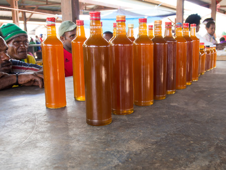 Wamena, Indonesia - January 23, 2015: The local bazaar. Men sell honeyのeditorial素材
