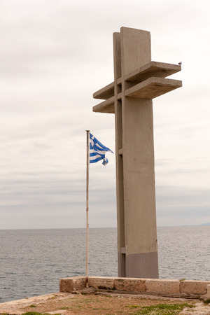 Piraeus, Greece-April 04, 2015: A huge Christian cross with the Greek flag on a port wharfのeditorial素材