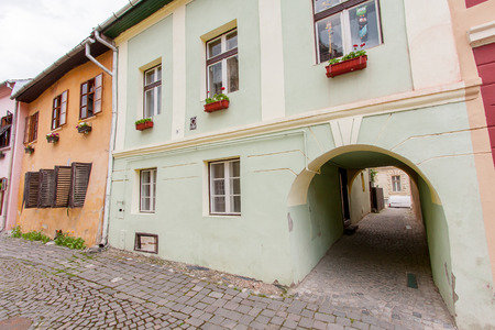 Sighisoara, Romania-July 03, 2015: The historic colourful houses among the empty cobbled streets of the townのeditorial素材