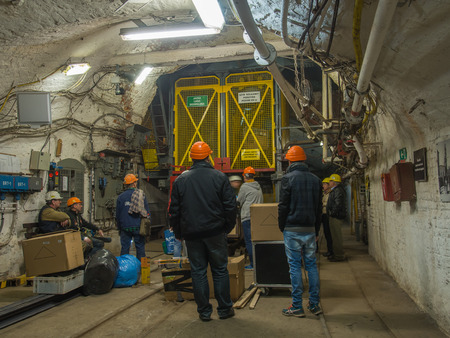 Ruda Slaska, Poland - November 05, 2015:  People wearing  helmets waiting for an elevator to a shaft...