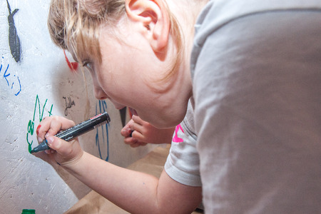 Jozefow, Poland - October 24, 2015:  Girl signing off her  work with a markerのeditorial素材