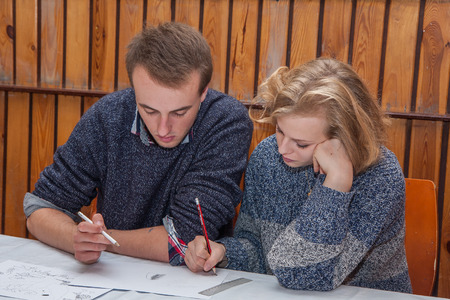 Jozefow, Poland - October 24, 2015:  A pair of teenagers working together on  a  paint work