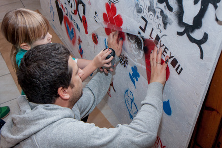 Jozefow, Poland - October 24, 2015: A teacher of painting providing guidance to a schoolgirlのeditorial素材