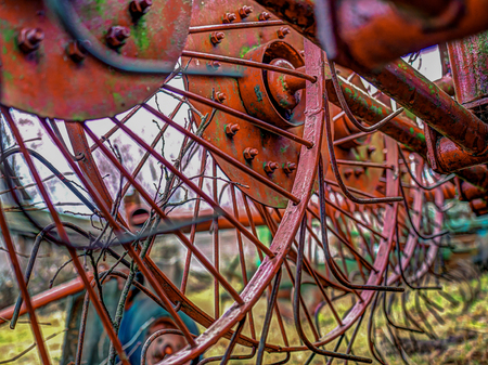 An agriculture machine being used to spread out hayの写真素材