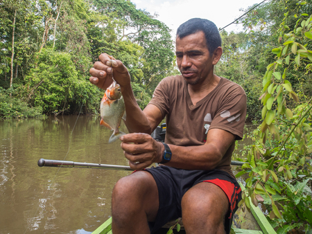 Palmari, Brazil - May 06, 2016: Resident of a Amazon jungle fishing  the piranha.のeditorial素材