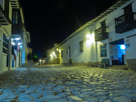Villa de Leyva, Colombia - May 02, 2016: The cobbled and antique  street of the city by night.のeditorial素材