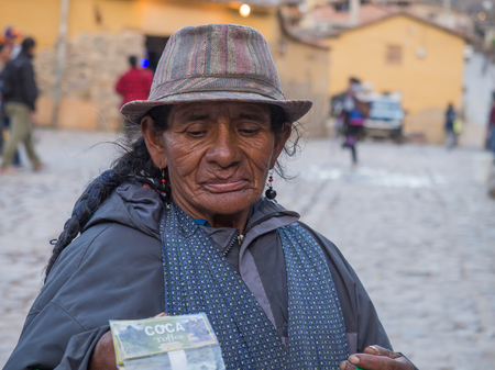 Ollantaytambo, Peru - May 20, 2016: Woman selling coca on  the  marketのeditorial素材