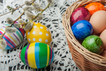 Coloured eggs and base in Easter basketの写真素材
