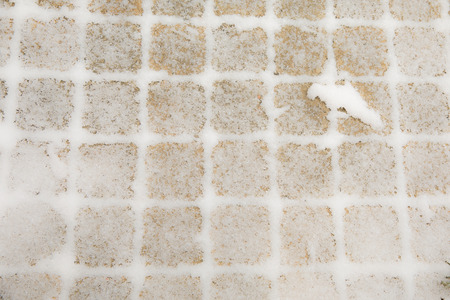 Background, texture. Light brown cube covered with a white coating of snowの写真素材