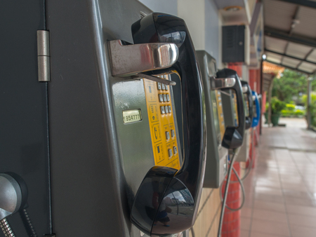 Luodong, Taiwan - October 18, 2016: More than a dozen of phones installed on the wall of a railway...
