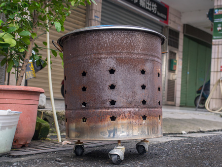 A stove  to burn fake  money notes standing in front of a house in Yilan, Taiwanのeditorial素材