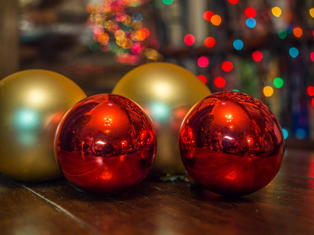 Christmas baubles over dark background with colorful, blurred  lights (bokeh)