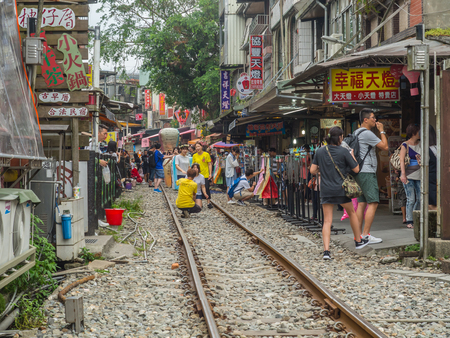 Shifen, Taiwan - October 05, 2016: Many people  on the railroad tracks  very close to buildingsのeditorial素材