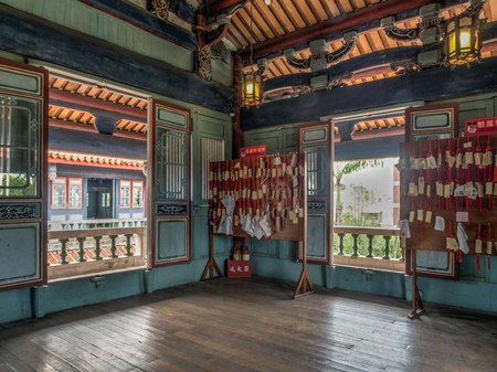 Tainan, Taiwan - October 11, 2016: Wooden tiles with wishes hanging  on red strings in Chihkan Tower building in Tainan. Students write their wishes on wood plates and leave them inside the shrine.のeditorial素材