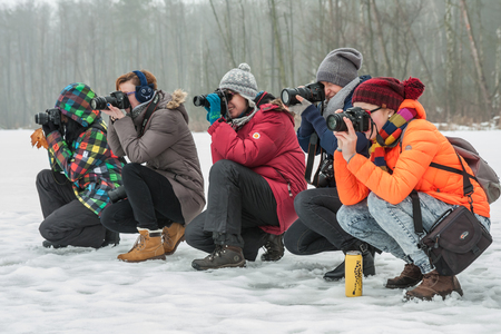 Otwock, Poland - January 21, 2017: People interested in photography take pictures during the winter outdoors photo sessionのeditorial素材