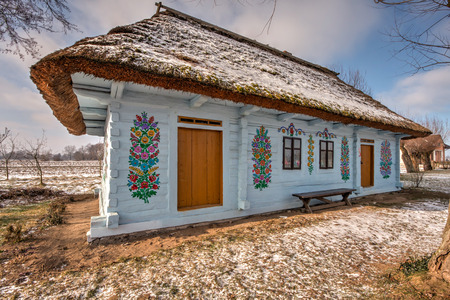 Zalipie, Poland - January  07, 2017: Colourful  log house in the yard of Felicia Curylowa in the village Zalipie in Malopolska, winter timeのeditorial素材