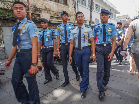 Jakarta,  Indonesia - January 11, 2015: Young soldiers in blue uniforms on the street of Jakartaのeditorial素材