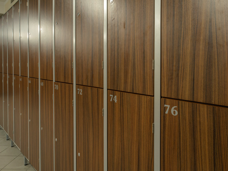 The row of wooden cabinets  in a fitness club dressing roomの写真素材