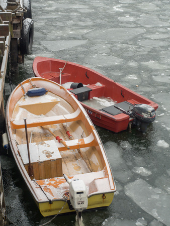 Oslo, Norway - February 16, 2017: Small motor-driven boats with paddles on the frozen fjord water in Oslo.のeditorial素材