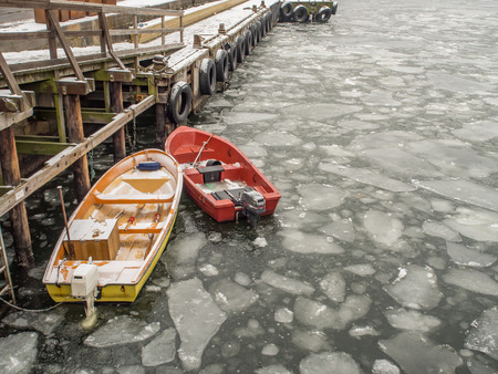 Oslo, Norway - February 16, 2017: Small motor-driven boats with paddles on the frozen fjord water in Oslo.のeditorial素材
