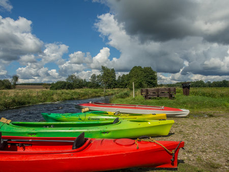 River Wieprza, Poland - August 23, 2017: Kayaks at a  bank of a the river Wieprzaのeditorial素材