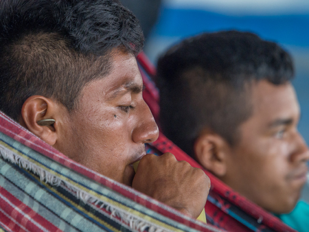 Amazon River, Peru - Dec 12, 2017: Portrait of man on the hammock â an inhabitant of the Peru.のeditorial素材