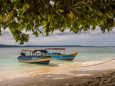 Ora Beach, Indonesia - February 12, 2018: Boats on the tropical beach of Ora Beach  Resort. Seram Island, Maluku, Indonesia,のeditorial素材