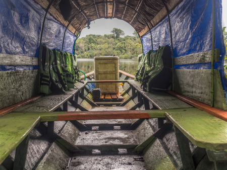 Wooden boat with colorful life jackets waiting for the tourists in the Amazon jungle.の写真素材