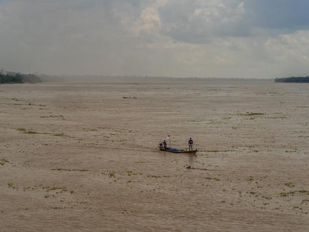 two mens on a boat in a riverのeditorial素材
