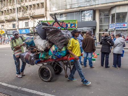 Bogota, Colombia - May 01, 2016: People with all their belongings walking through the streets of Bogotaのeditorial素材