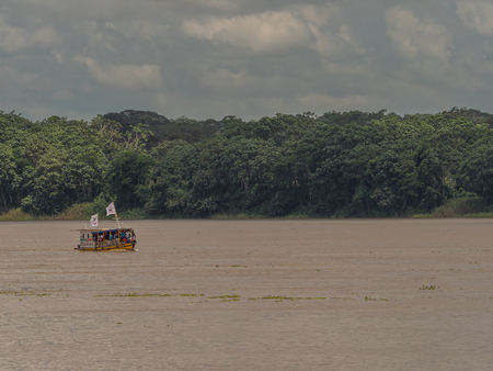 Boat nn the endless water of the Amazon river.