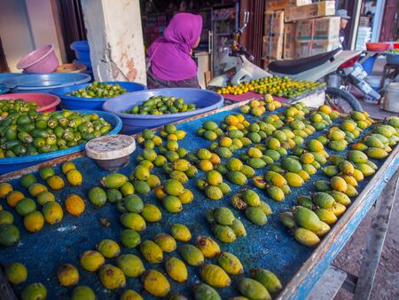 Wamena, Indonesia - January 23, 2015: Local people selling betel nuts on the street in Wamena city.のeditorial素材