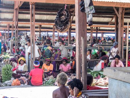 Wamena, Indonesia - January 23, 2015: Local people selling different goods on the bazaar in Wamena.のeditorial素材