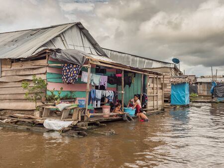 Belen, Peru- March 27, 2018: Family doing laundry in the river.  Floating houses in the floodplain of the Itaya River, poorest part of Iquitos - BelÃ©n. Venice of Latin America.Region Loreto, Province Maynas.のeditorial素材