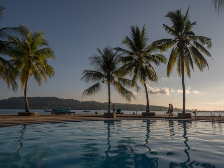 View with palm trees around luxury swimming pool during on the tropical island. Ambon Island. Indonesiaのeditorial素材