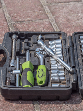 Set of ratchet sockets, socket wrenches, flat wrenches in a plastic, portable box.