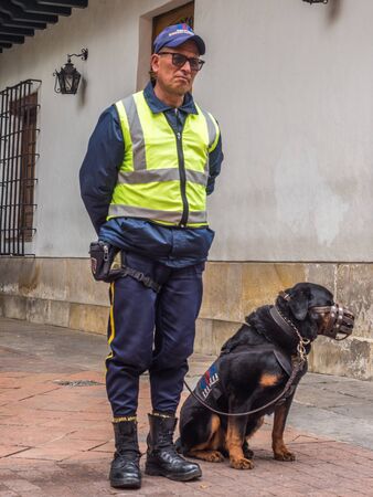 Bogota, Colombia - September 13, 2013: Policeman with dog on the street of Bogota. 
Plazoleta de Cuervo. La Candelaria.のeditorial素材