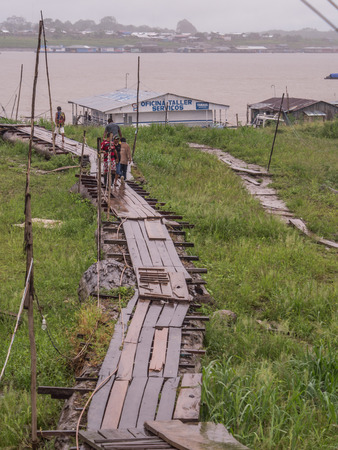 Tabatinga, Brazil - September 15, 2018: Way to the port during a rainy day at the port of the Amazon.  Low water level. Tres Fronteras. Latin America. Amazonia.のeditorial素材