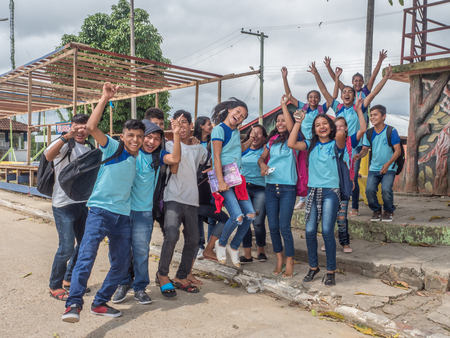 Atalaia do Norte, Brazil - September 21, 2018: Young people in blue school uniform on the street of village in the Amazon jungle.のeditorial素材