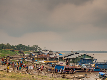 Tabatinga, Brazil - May 05, 2016: A Huge traffic of different types of boats in the port of Amazon river. Low water season.のeditorial素材