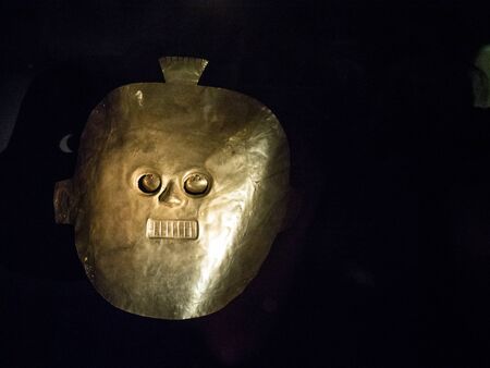 Bogota, Colombia - November 23, 2018: Interior of the Museum of Gold. Golden maskのeditorial素材